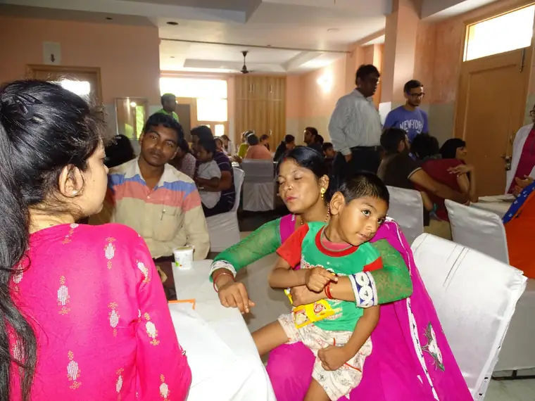 A doctor examining a child with the mother present