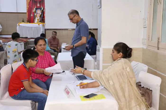 A doctor examining a child while the parents answer questions